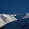 Snowy peaked mountains in sunny weather. Blue sky. Ski resort. Beautiful natural mountain landscape. Generated AI