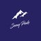 Snowy peaks logo mountain emblem. Silhouette of snowy mountains with lettering.