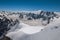 Snowy peaks and mountaineers in a sunny day, viewed from the Aiguille du Midi, near Chamonix.