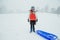 Snowy Portrait of a Girl with Sled