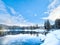 Snowy Retreat: Lakeside Cabin in a Wintery Pine Forest