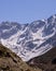 Snowy road between the mountains of Cajon del Maipo, Road to El Yeso Reservoir vertical