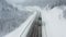 Snowy road runs through the forest in the mountains through the pass in December. The car rides through the winter snowy