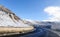 Snowy road under freezing blue sky