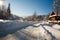 Snowy road in winter village sunshine with blue sky