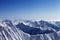 Snowy rocks and blue sky in nice sun day, view from off piste slope