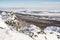 Snowy rocks, forest and fields, seasonal landscape