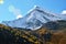 Snowy rocky mountain with alpine in autumn with clear sky