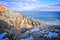 Snowy and rocky overlook of the ocean and coast during winter