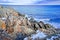 Snowy and rocky overlook of the ocean and coast during winter