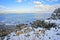 Snowy and rocky overlook of the ocean and coast during winter