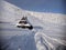 Snowy roof of a mountain cottage among the snowdrifts