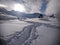 Snowy roof of a mountain cottage among the snowdrifts