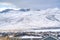 Snowy rooftops of homes with a striking view of snow covered mountain in winter