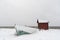 Snowy rowing boat and a boathouse