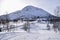 Snowy scenes in Hovden, Norway. Ski tracks on the ground, with Mountains and trees behind. Blue skies. Bluebird weather.