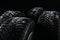 Snowy set of wheels with winter tires on black background, closeup. Space for text