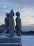 Snowy statues of boys looking up