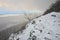 Snowy stony hill. Mountain top in winter