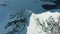 Snowy Top and Ridge of Mountain in European Alps in Sunny Day. Aerial View