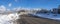 Snowy town with houses at Draper, Utah with snow plowed road and a view of Wasatch mountains