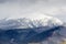 Snowy treeless mount and forested slopes in the Carpathian Mountains