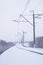 Snowy trees along a railway