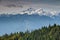 Snowy Triglav peaks rise above forests in Julian Alps Slovenia