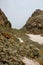 Snowy Tsashkibuli mountain pass in Caucasus Mountains on a hiking trail leading to Silver lakes in Georgia