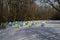 Snowy view toward apiary with bee hive in the winter field at deciduous forest, Zavet town