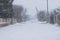 A snowy village street during a snow storm.