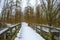 Snowy white edge of a cold lake in a field in wetland in winter