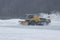 Snowy winter at the airport and snowplow removes snow