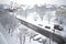 Snowy winter city view from the window. Snowstorm and snow covered street and cars