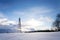 Snowy winter country with transmitters and aerials on telecommunication tower