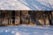 snowy winter day, large old barn facade where many