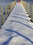 Snowy winter dock with pier shadows