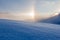 Snowy winter landscape in the alps, sunrise with halo phenomena