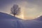 Snowy winter landscape in the alps, sunrise with halo phenomena