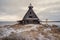 Snowy winter landscape with authentic cinematic house on the shore in the Russian village Rabocheostrovsk