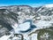 Snowy winter landscape of Goynuk Cubuk lake and windmills with aerial drone. Bolu - Turkey