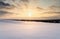 Snowy winter landscape at sunset, smooth snow covered