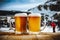 Snowy winter mountain background with two glasses of beer and space for products and decorations.