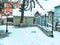 Snowy winter noon. Snow covered trees, the roofs of small houses in the yard. Mountain ski resort Bakuriani