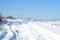 Snowy winter road in the field. Deep snow