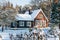 Snowy wooden house in the forest