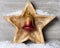 Snowy wooden star with christmas bell