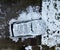 snowy yard with terrace. the parked car is subtly camouflaged in outline.