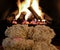 Snuggling teddy bears by fireplace