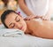 Soaking up some well-deserved pampering. an attractive young woman getting an exfoliating treatment at the spa.